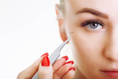 Kirpik uzatma prosedürü. Uzun kirpikli kadın gözü. Yaklaş, seçici odaklanma.