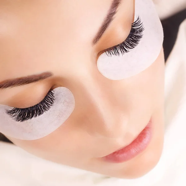 Eyelash Extension Procedure. Woman Eye with Long Eyelashes. Close up, selective focus. — Stock Photo, Image