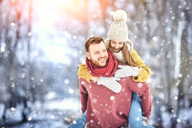 Winter Park mutlu genç gülen ve having fun çift. Aile açık havada.