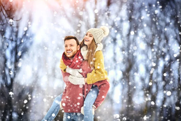 Winter Park mutlu genç gülen ve having fun çift. Aile açık havada.