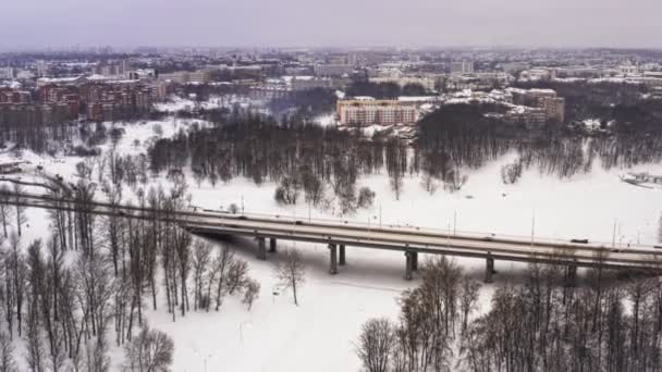 Havas téli gyönyörű város vagy város. Klip. Szemközti nézet a fagyasztott river, sok autó úton, régi épületek. Hangulatos téli időszak alatt a nagy város. Csodálatos panoráma — Stock videók