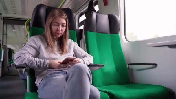 Kvinna som använder smartphone i ett tåg. — Stockvideo