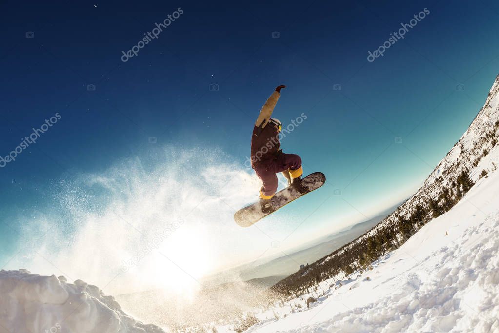 Snowboarder makes long jump from springboard