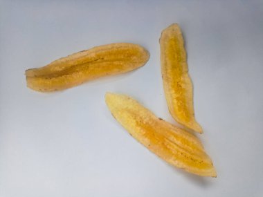 Beyaz arka planda izole edilmiş taze muz cipsi yığını.