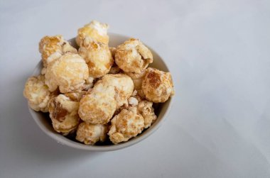 Düşen patlamış mısır seramik bir kabın içinde ve çevresinde levitating. Yan görünüm.