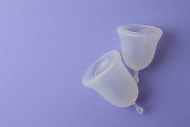 Mor bir kesedeki bu yeniden kullanılabilir regl bardakları sürdürülebilir kadın hijyen uygulamalarını teşvik eder.