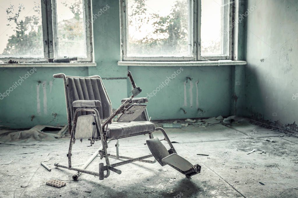 Broken wheelchair in abandoned medical sanitary unit number 126 in Pripyat, Chernobyl alienation zone