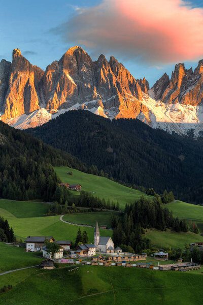 Beautiful idyllic mountain scenery in the Dolomites in golden evening light at sunset in fall colours, Val di Funes, South Tyrol, northern Italy