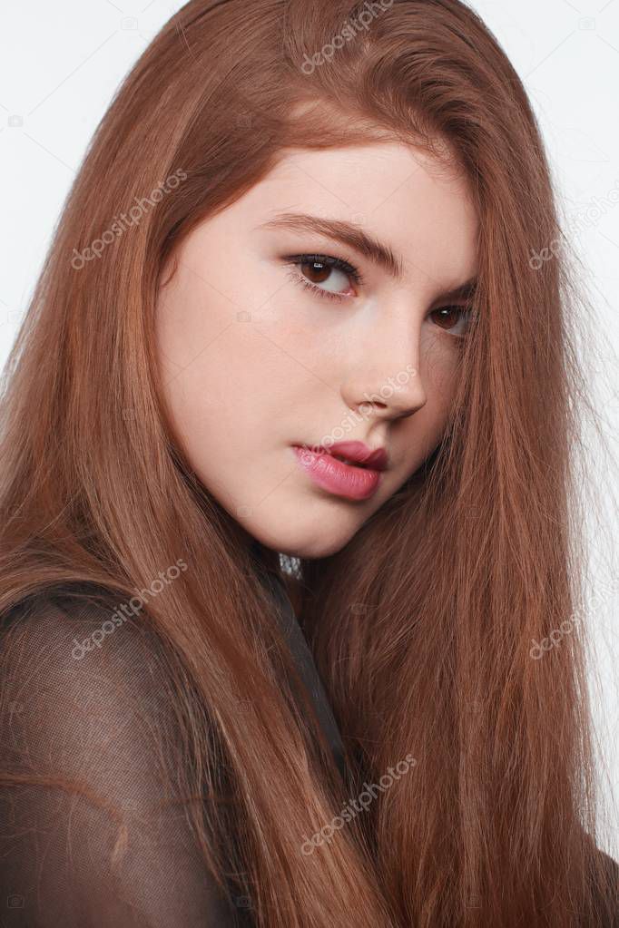 Portrait of young woman with a beautiful hair and make-up. White background