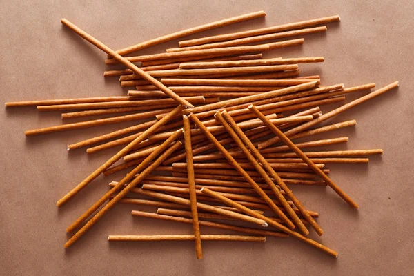 Crispy bread straw on brown paper background — Stock Photo, Image