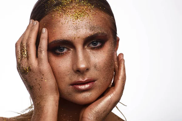 Portrait of a beautiful woman with expressive creative make-up in bronze. Studio beauty photo session — Stock Photo, Image