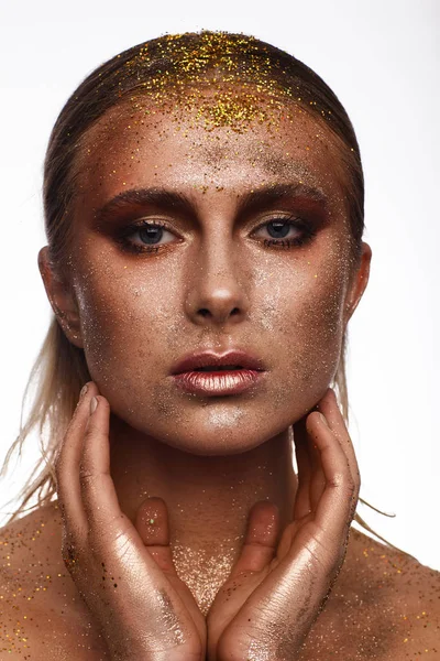 Portrait of a beautiful woman with expressive creative make-up in bronze. Studio beauty photo session — Stock Photo, Image