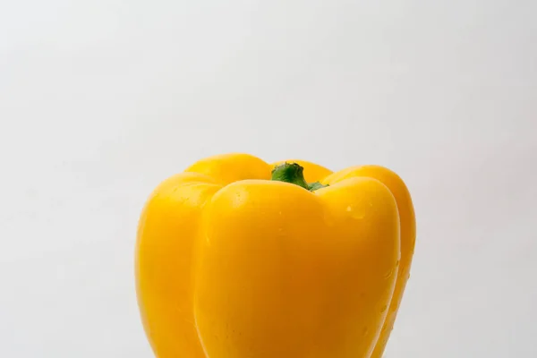 Whole fresh yellow pepper vegetable isolated on white