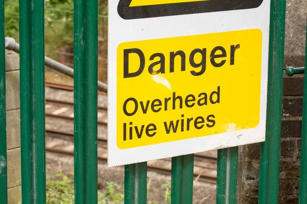 Warning sign of live wires on the railway track