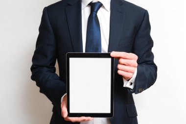 Bir tablet aygıtı bir Met giyen boş beyaz ekran ile tutan adam