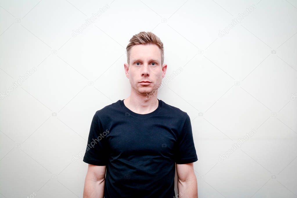 Man looking directly into camera, model not smiling and facing f