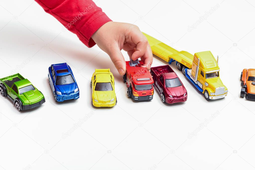 Child playing Boy plays with toy cars close up on hands