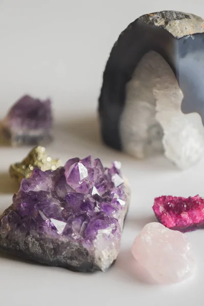Collection of natural minerals and gemstones on a white table