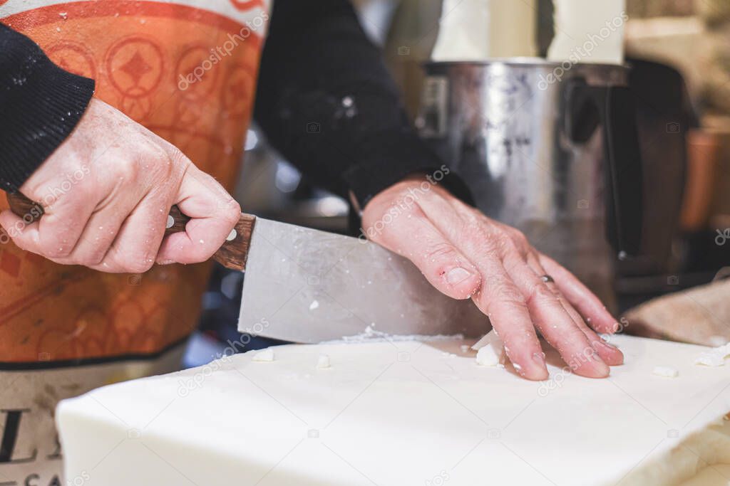 Cutting wax from a raw ingredient block to make scented candles