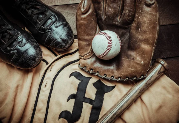 Vintage baseball gear on a wooden background