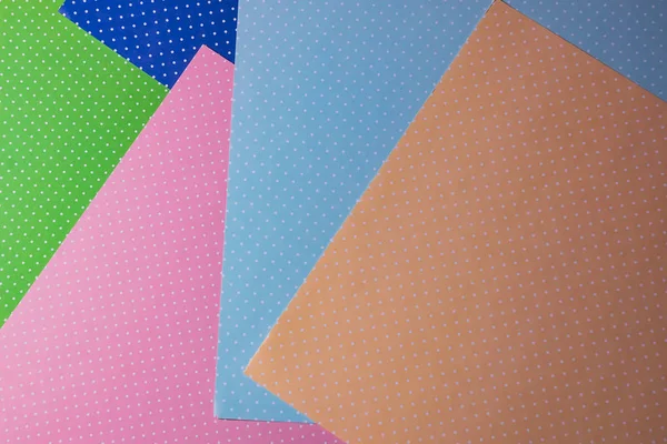 Multi colored abstract paper of pastel colors; with geometric shape; flat lay, minimalism style.