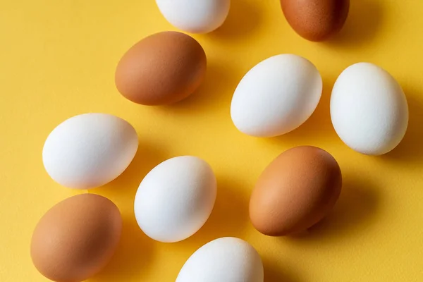 Eggs pattern over yellow pastel background.