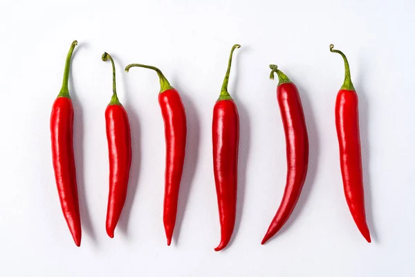 Red ripe chili spicy peppers over white background.