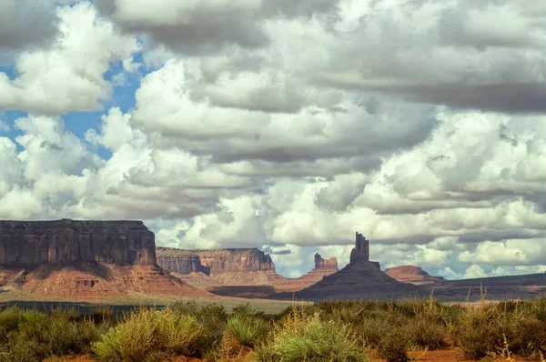 Travel through the national parks of the southwestern United States: a view on the rock formations of monument Valley in Utah. Uneven dirt road.