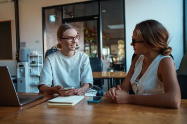 İki deneyimli profesyonel, modern ve enerjik bir çalışma alanı içinde düşünceli bir işbirliği içinde tartışırlar.