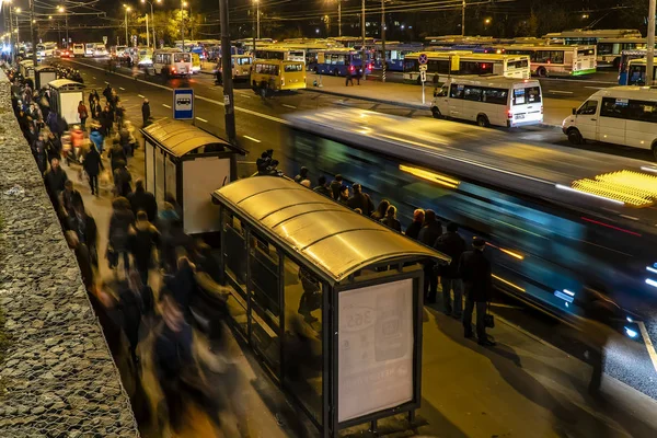 Passageiros que esperam e embarcam ônibus no terminal de ônibus — Fotografia de Stock