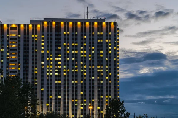 The Windows of the big hotel are shining warmly against the back — Stock Photo, Image