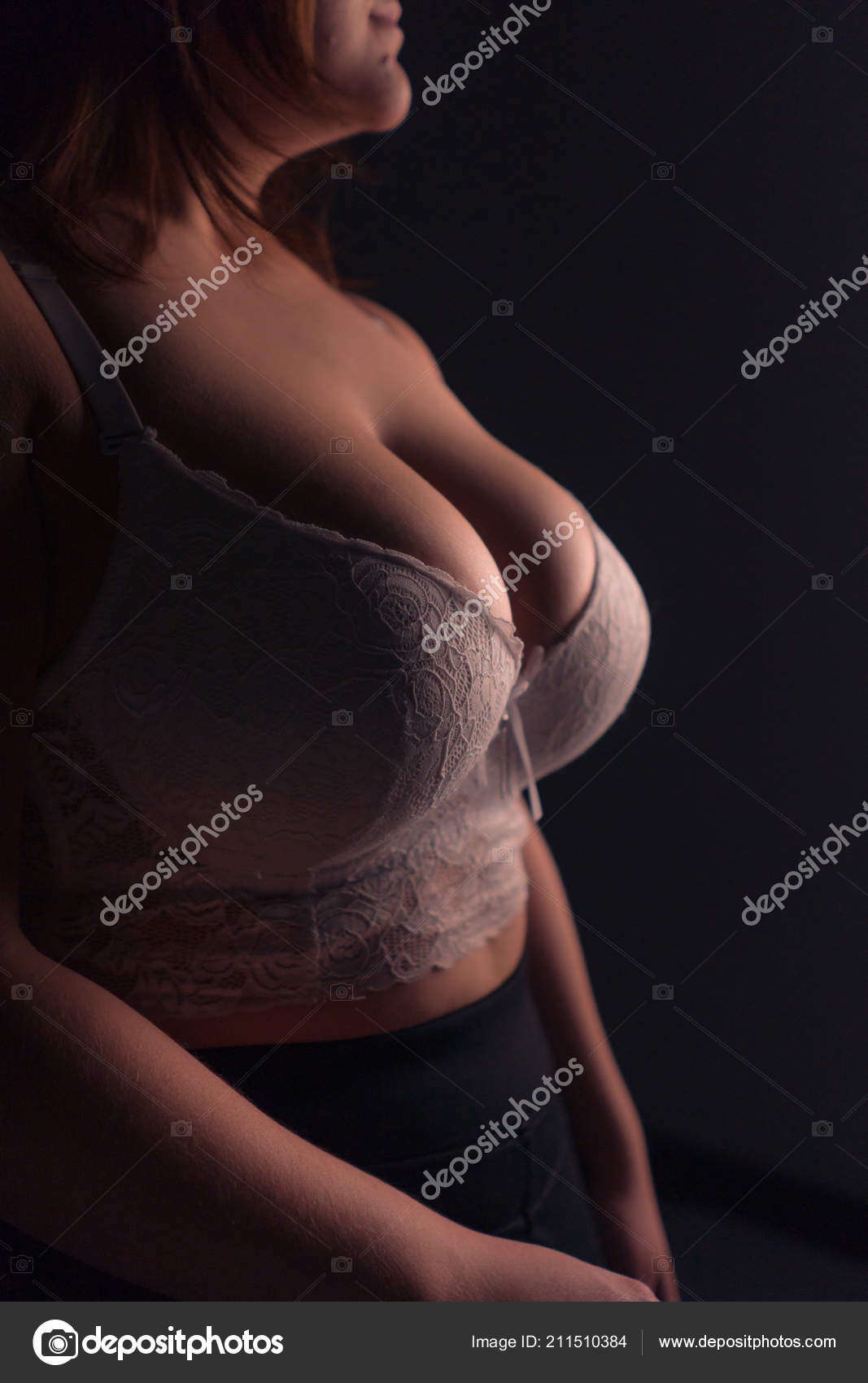 Young beautiful busty curvy plus size model with big breast in white bra,  xxl woman. Black background. Stock Photo by ©2735369.mail.ru 211510384