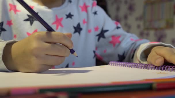 Close-up of childrens hands. Creative child draws with colored pencil — Stock Video