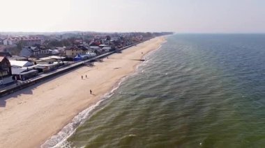 Wide sandy beaches, spring light, promenade walks, and gentle Baltic waves frame Sarbinowo and village life adding timeless charm.
