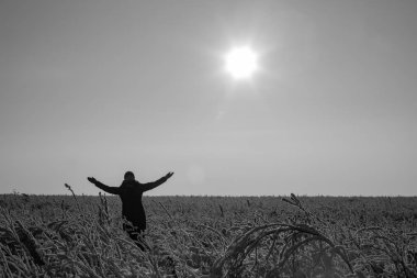 The girl rejoices in the sun and winter. Winter landscape. Sunny frosty day