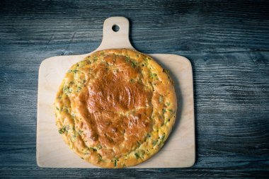 Taze lezzetli turta masanın üzerindeki kesme tahtasının üzerinde duruyor. Sıcak yemek.