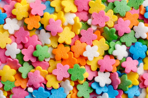 Sugar sprinkle flowers, decoration for cake and bekery, a lot of sprinkles as background close up