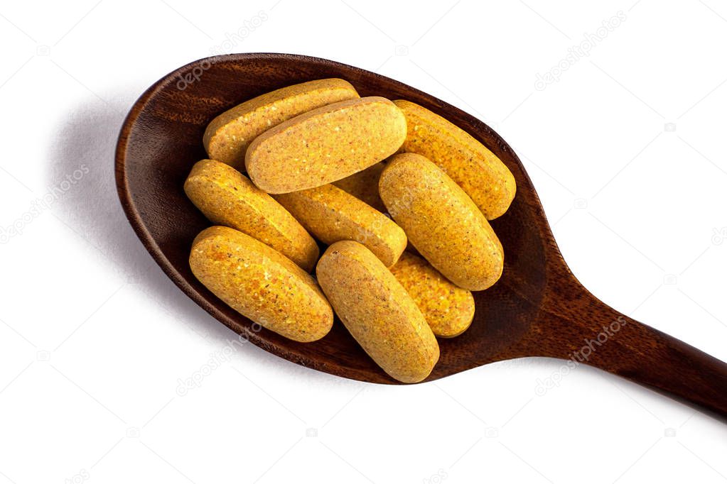 wooden spoon with pills isolated