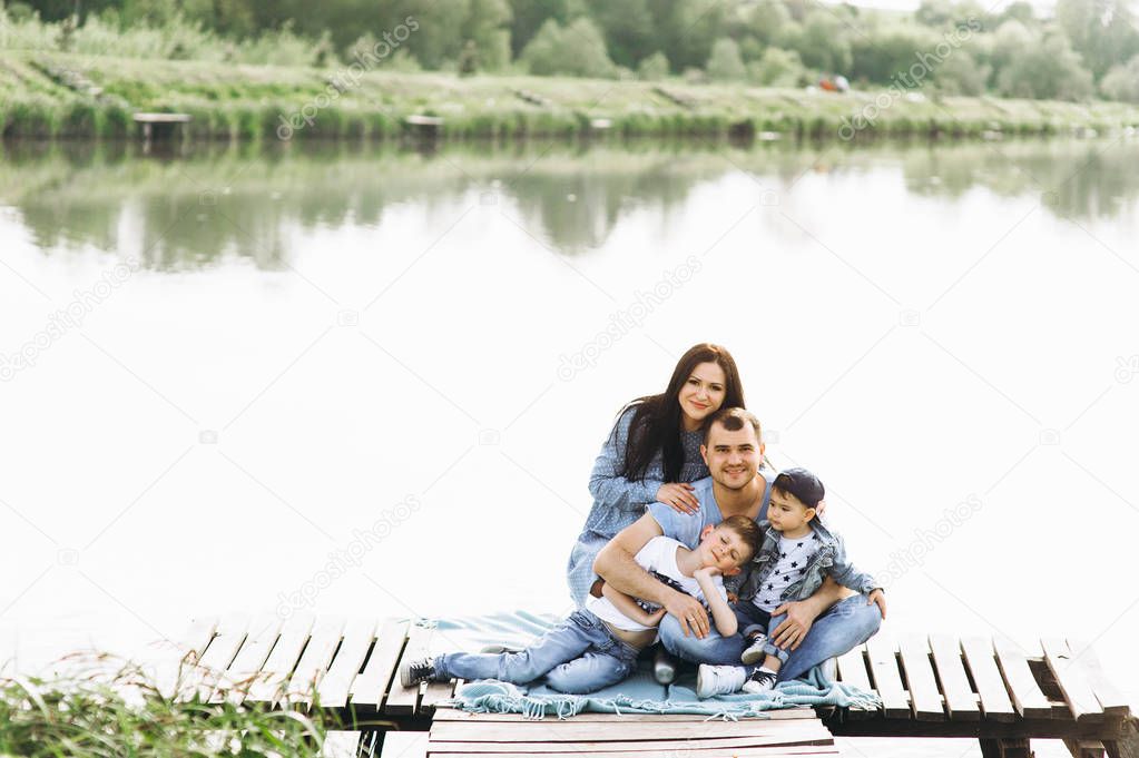 happy family with two children near the river