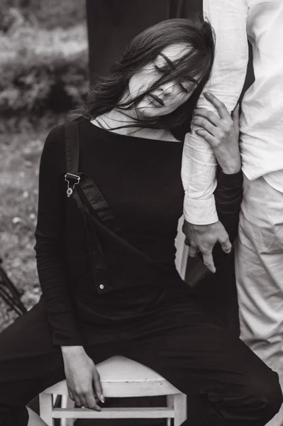 beautiful young  couple on a black background is full of emotions