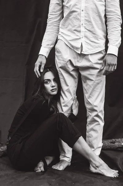 beautiful young  couple on a black background is full of emotions