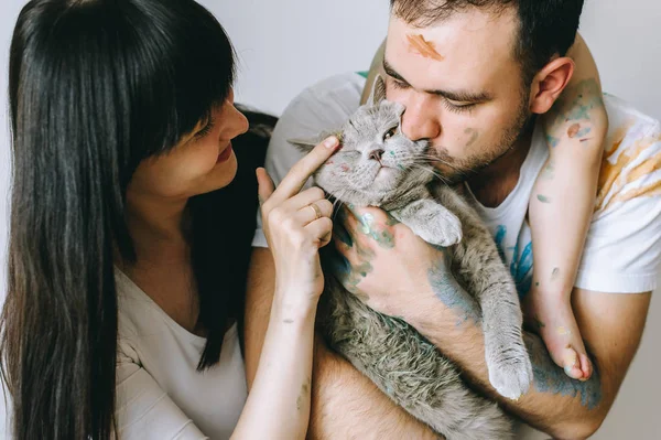 couple with a cat on a white background after playing paint