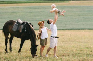 Genç aile eğlenceli bir alanı var. Anne ve çocuk alanında bir atı ile 