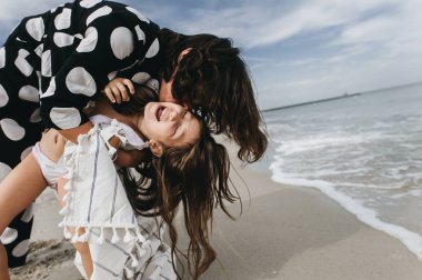 Anne ve kızı kumsalda eğleniyor