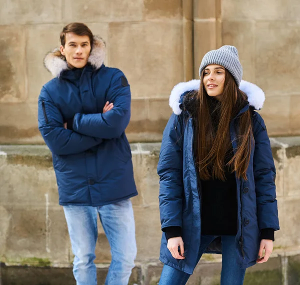 A trendy young couple walks in the city at christmastime