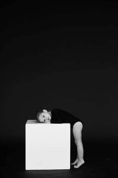 A portrait of beautiful little girl dressed in black tights on a — Stock Photo, Image