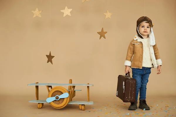 concept of dreams and travels. pilot aviator child with a toy ai