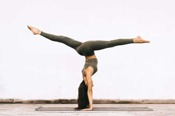 Attraktiv modell i yoga poserar på vit bakgrund i sexuella clot — Stockfoto