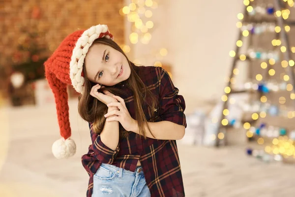 A portrait of a little girl in a Christmas decorated house in a — Stock Photo, Image