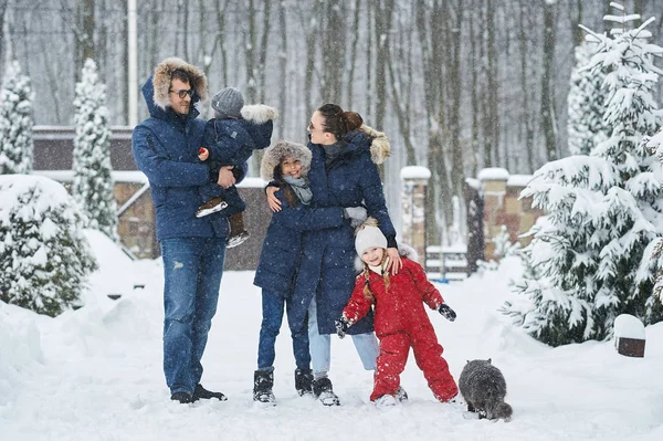 Happy family have a fun outside near the house in winter — Stock Photo, Image